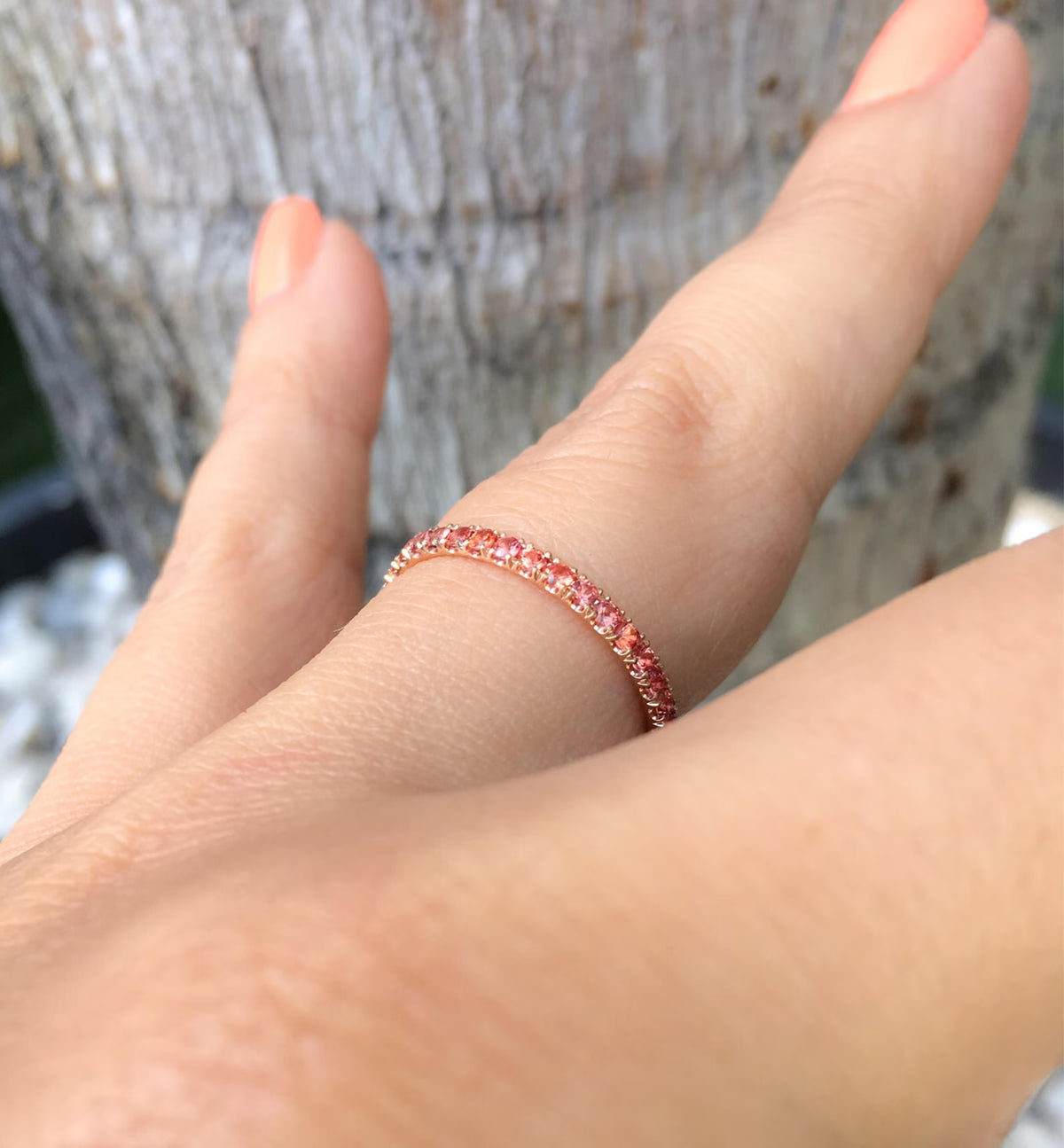 peach color gemstone stacking ring on finger, from the side it shows the u-style set symmetric prongs 