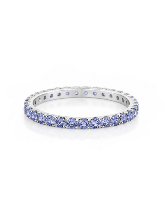 White gold eternity band ring set with round tanzanite gemstones