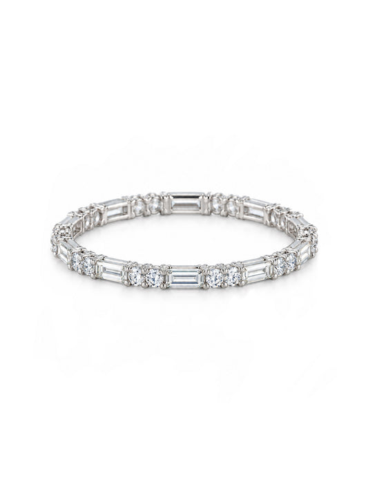 white stacking ring featuring 1 baguette and 2 round-cut clear stones, displayed on a clean white background
