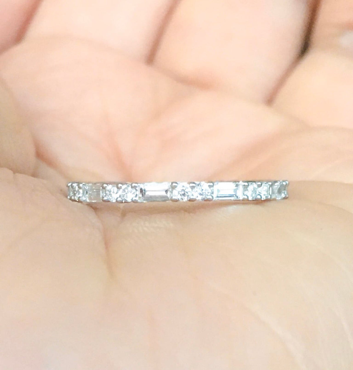 stacking ring with round and baguette cut diamonds on  palm